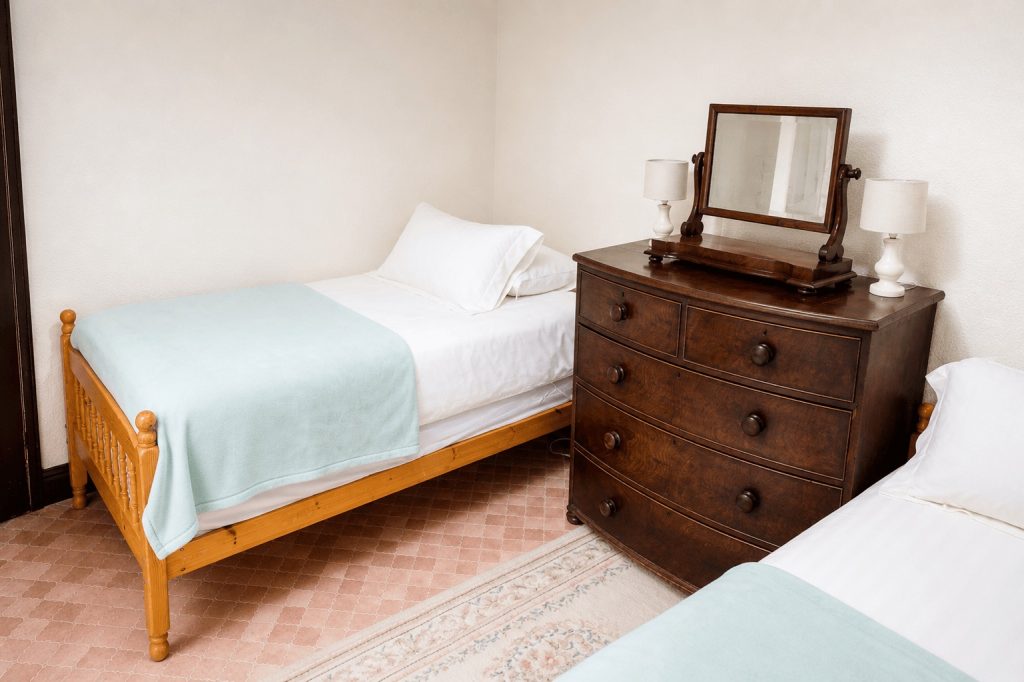 Small twin bedroom with washbasin at Windy Gap